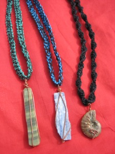 From left to right: richolite, kyanite, and ammonite necklaces