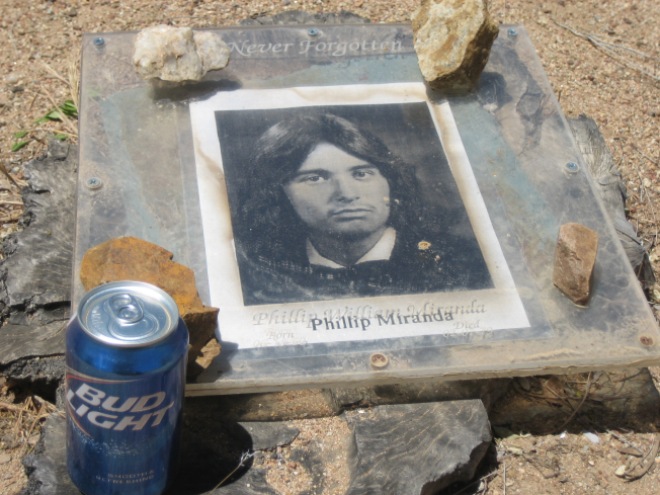 The man in the photo was 19 when he died. His grave site was right next to the other one with a Bud Light left as an offering.