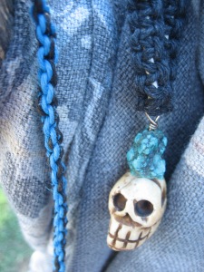 Necklace with pendant of skull carved from smoked yak bone and turquoise.